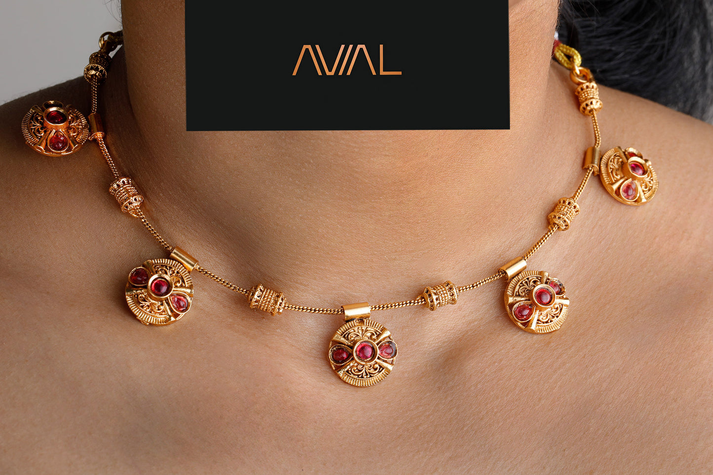Close-up of antique gold necklace with red stone round motifs – traditional temple jewellery for Indian weddings UK