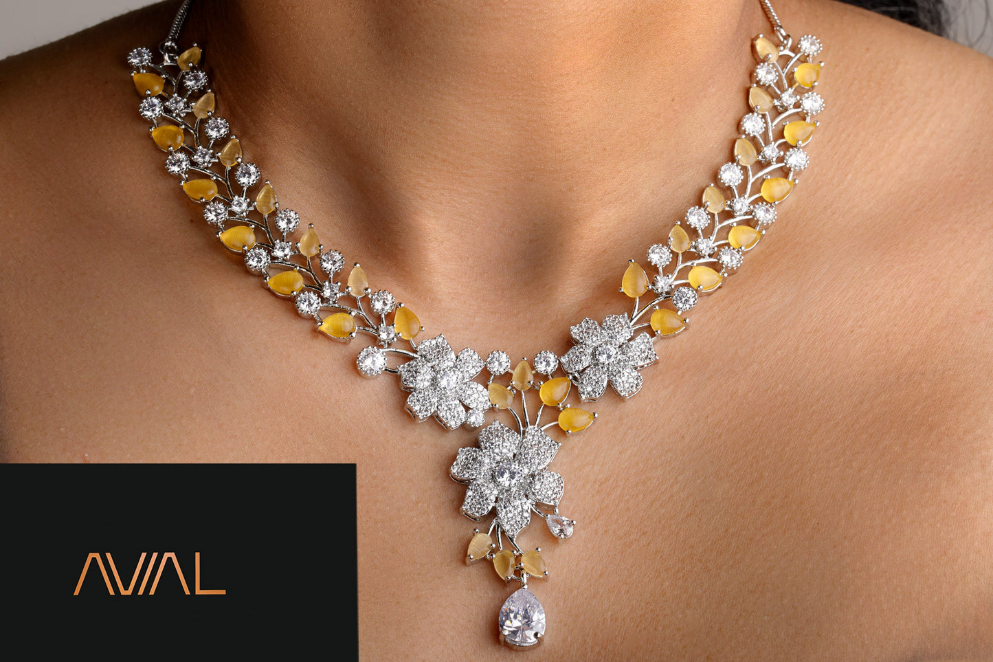 Close-up of silver necklace with yellow floral gemstones and sparkling American diamonds – festive and wedding jewellery UK