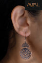 Model wearing antique bronze boho earrings with tribal geometric carving – handmade ethnic hook dangle jewellery for women