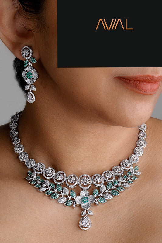 Model wearing floral green and white American diamond necklace set with matching earrings – silver-tone jewellery for weddings and special occasions UK