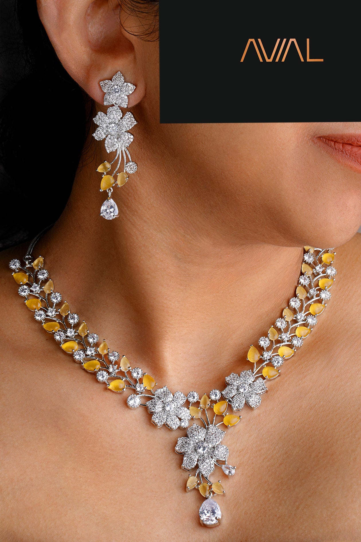 Model wearing yellow and white floral necklace set with American diamonds – silver statement jewellery for weddings and UK occasions