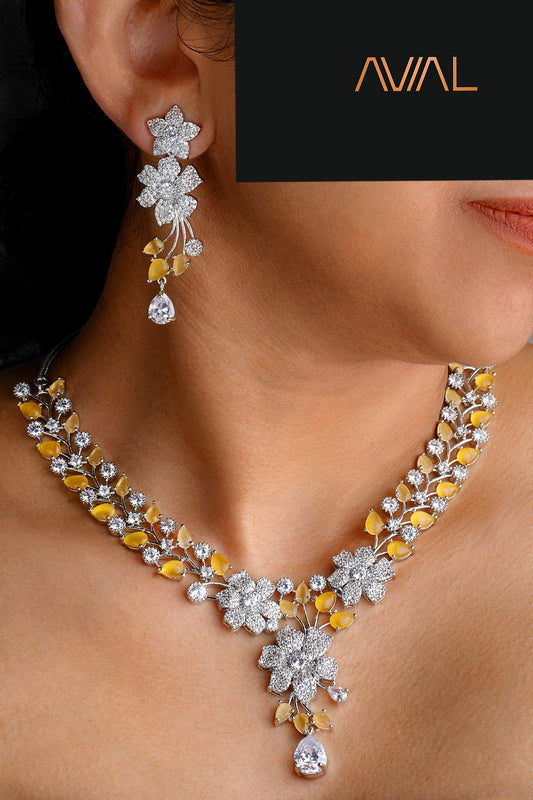 Model wearing yellow and white floral necklace set with American diamonds – silver statement jewellery for weddings and UK occasions