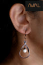 Handmade teardrop copper earrings with white bead, worn on model – artisan boho jewellery by Avial Stores UK