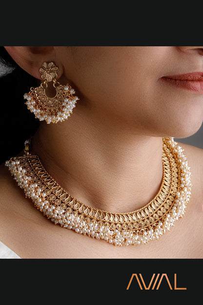 Emple South Indian temple jewelry bridal set with gold finish and pearl accents — necklace and earrings