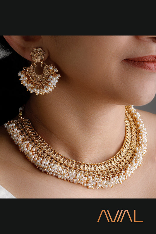 Emple South Indian temple jewelry bridal set with gold finish and pearl accents — necklace and earrings