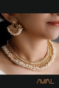 Emple South Indian temple jewelry bridal set with gold finish and pearl accents — necklace and earrings